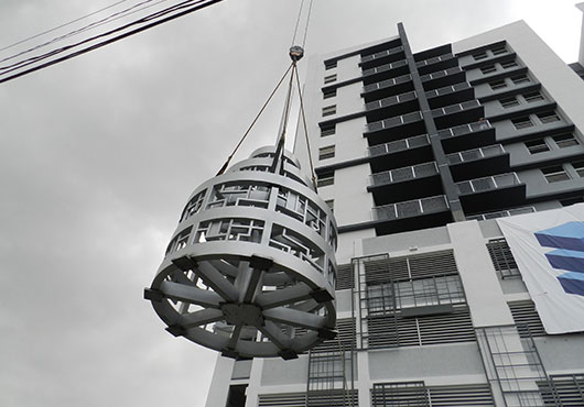 Capitol Steel Structures hoists a beacon structure on top of the Beacon Apartments building in downtown Miami.